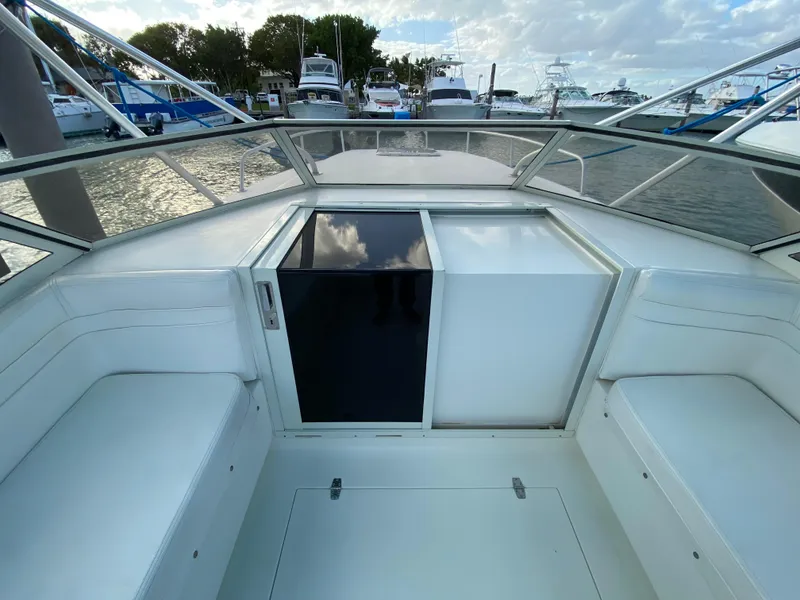 Slide: The Image of 1998 Contender 35 Express boat interior with seating, docked at marina. - 37