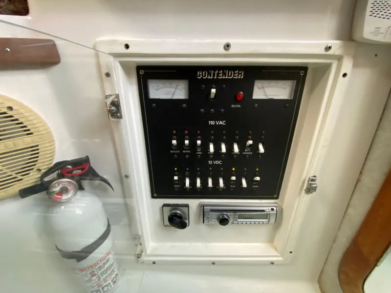 Slide: The Image of Control panel of a 1998 Contender 35 Express boat with fire extinguisher. - 41