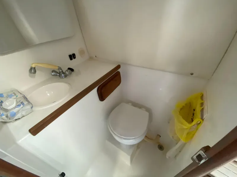 Slide: The Image of 1998 Contender 35 Express boat bathroom with sink and toilet. - 44