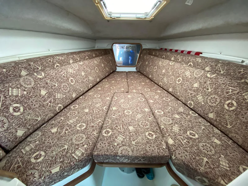 Slide: The Image of 1998 Contender 35 Express cabin interior with patterned cushions and overhead hatch. - 46