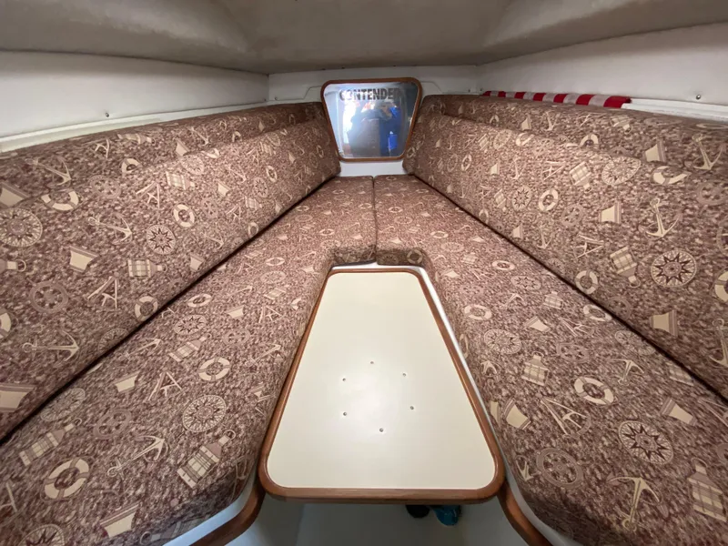 Slide: The Image of 1998 Contender 35 Express cabin with patterned cushions and compact table. - 47