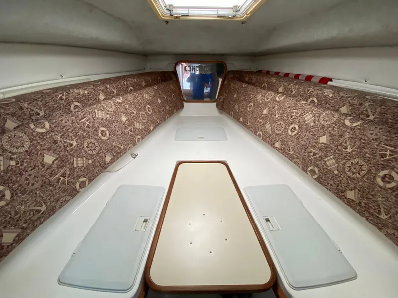 Slide: The Image of Interior cabin of a 1998 Contender 35 Express boat with patterned walls and table. - 48