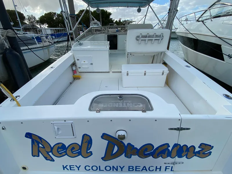 Slide: The Image of 1998 Contender 35 Express boat docked, featuring "Reel Dreamz" signage, Key Colony Beach, FL. - 5