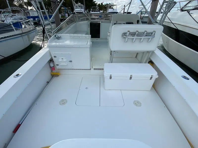 Slide: The Image of 1998 Contender 35 Express boat deck with storage and seating. - 7