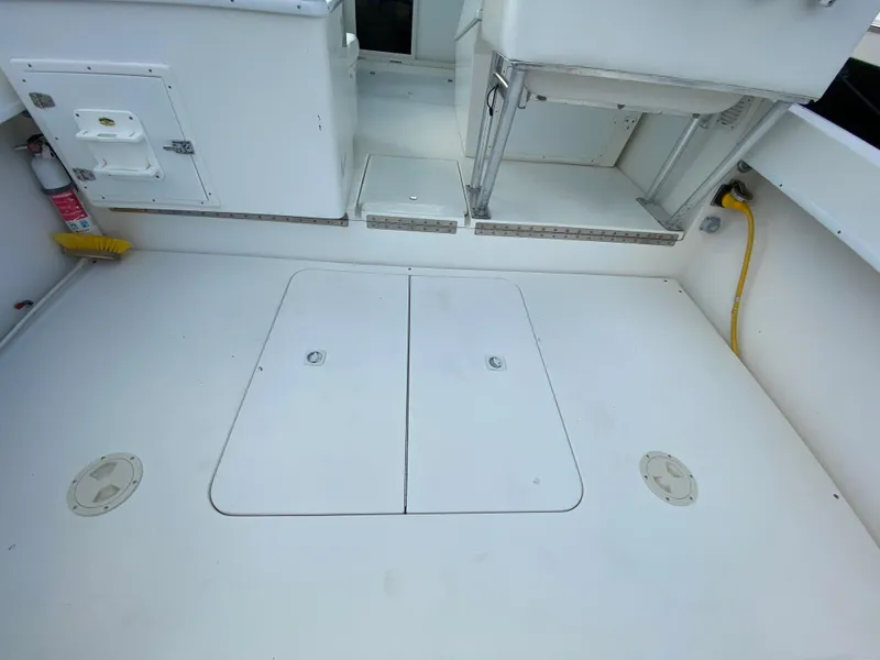 Slide: The Image of 1998 Contender 35 Express boat deck with storage hatches and clean white surface. - 8