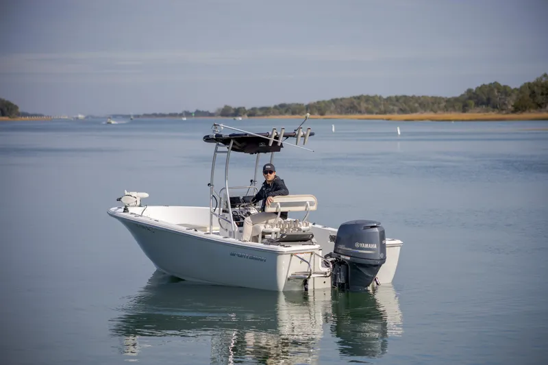 Slide: The Image of 2017 Sportsman Island Reef 19 Center Console boat on calm water, with a person onboard. - 5