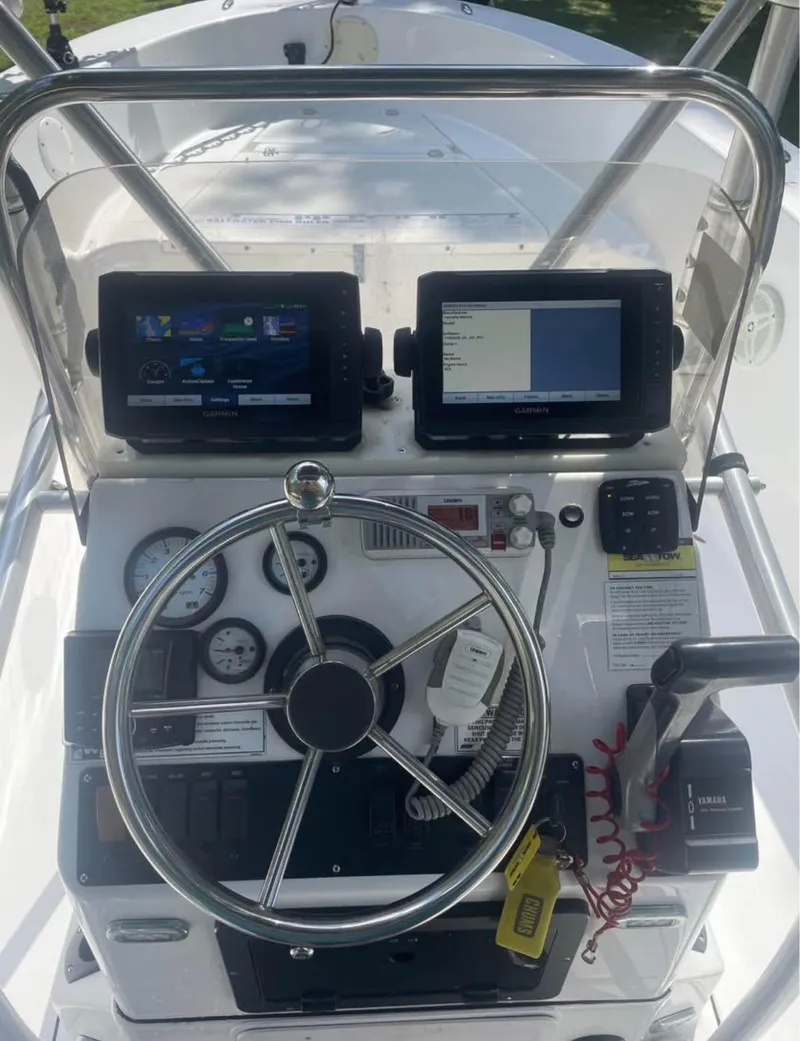 Slide: The Image of 2017 Sportsman Island Reef 19 Center Console dashboard with steering wheel and dual displays. - 6