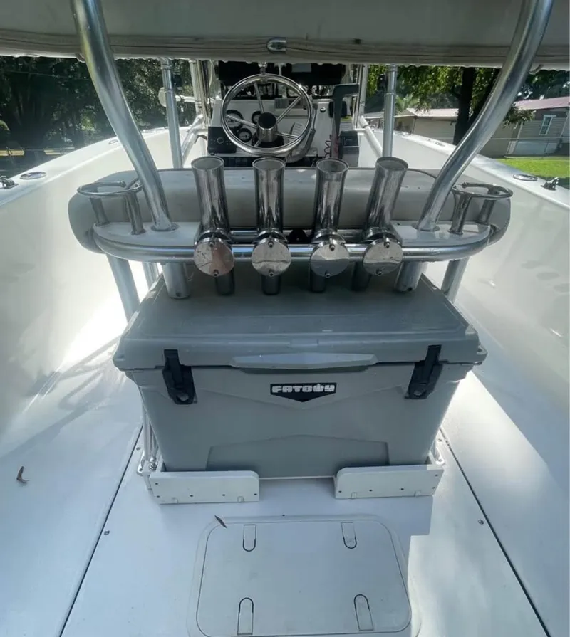 Slide: The Image of 2017 Sportsman Island Reef 19 Center Console with rod holders and cooler on deck. - 8