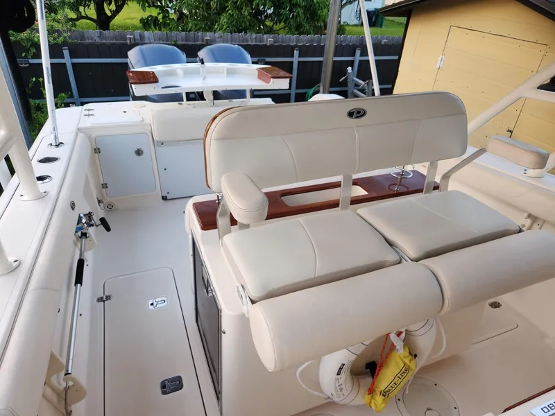 Slide: The Image of 2011 Pursuit S 280 Sport boat interior with cushioned seating and storage compartments. - 10