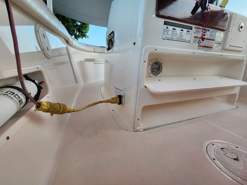 Slide: The Image of 2011 Pursuit S 280 Sport boat interior with power connection and safety equipment. - 11