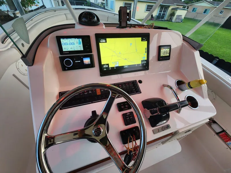 Slide: The Image of 2011 Pursuit S 280 Sport boat dashboard with navigation and control systems. - 14