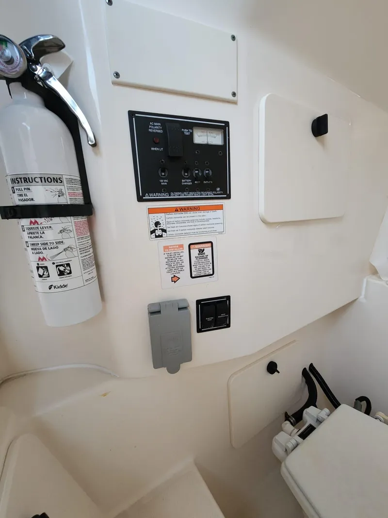Slide: The Image of Interior of 2011 Pursuit S 280 Sport boat with control panel and fire extinguisher. - 16