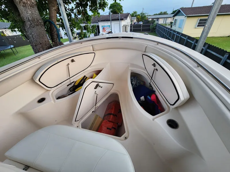 Slide: The Image of 2011 Pursuit S 280 Sport boat storage compartments with gear and equipment. - 18
