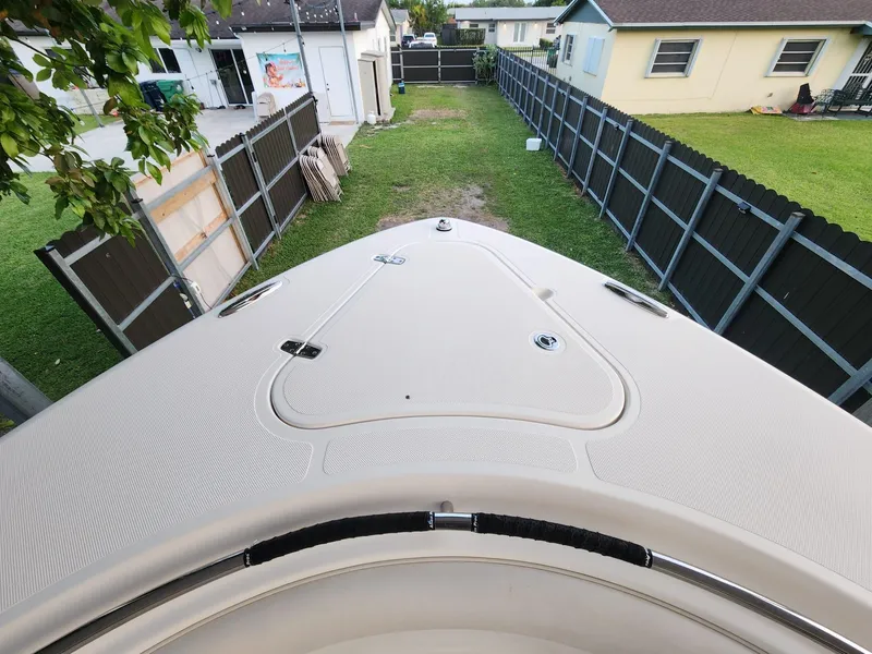 Slide: The Image of 2011 Pursuit S 280 Sport boat parked in a residential backyard. - 19