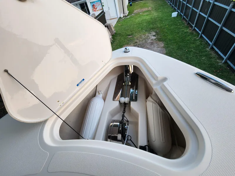 Slide: The Image of 2011 Pursuit S 280 Sport boat anchor compartment with open hatch. - 20