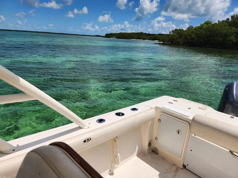 Slide: The Image of Pursuit S 280 Sport boat on clear turquoise water, 2011 model. - 22