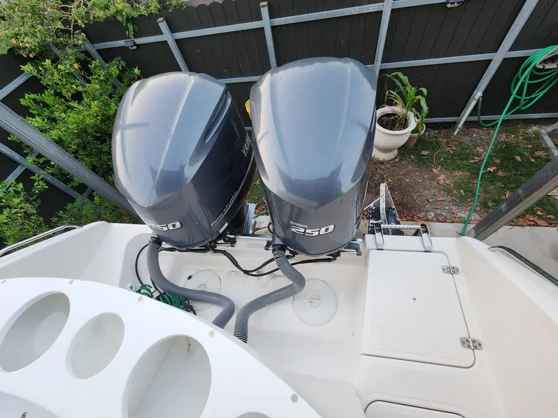 Slide: The Image of 2011 Pursuit S 280 Sport boat with dual 250 horsepower engines, docked near greenery. - 5