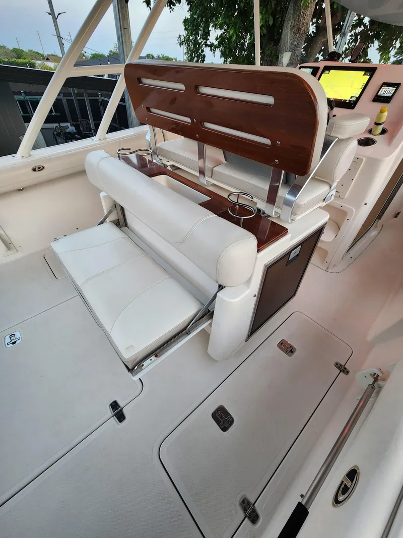 Slide: The Image of 2011 Pursuit S 280 Sport boat interior with seating and control panel. - 7