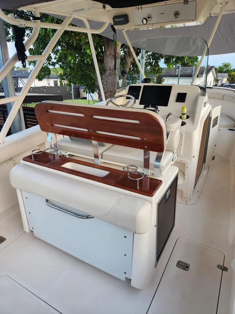 Slide: The Image of 2011 Pursuit S 280 Sport boat interior with helm and seating area. - 8