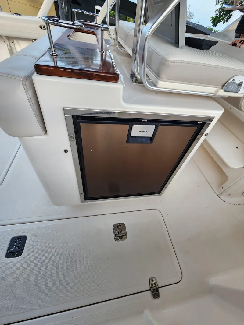 Slide: The Image of 2011 Pursuit S 280 Sport boat interior with storage compartment and seating. - 9