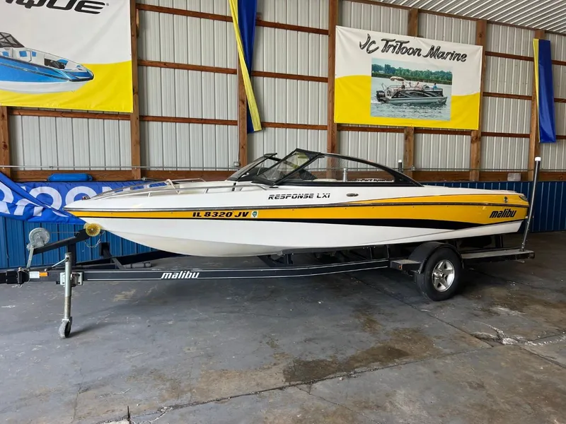Slide: The Image of 2004 Malibu 20 Response LXI boat on trailer in showroom. - 0
