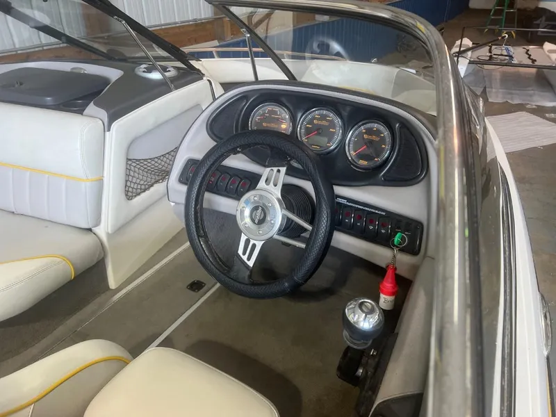 Slide: The Image of 2004 Malibu 20 Response LXI boat interior with steering wheel and dashboard gauges. - 11