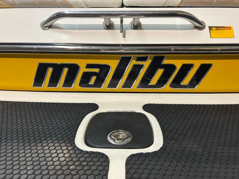 Slide: The Image of 2004 Malibu 20 Response LXI boat with yellow and black branding. - 14