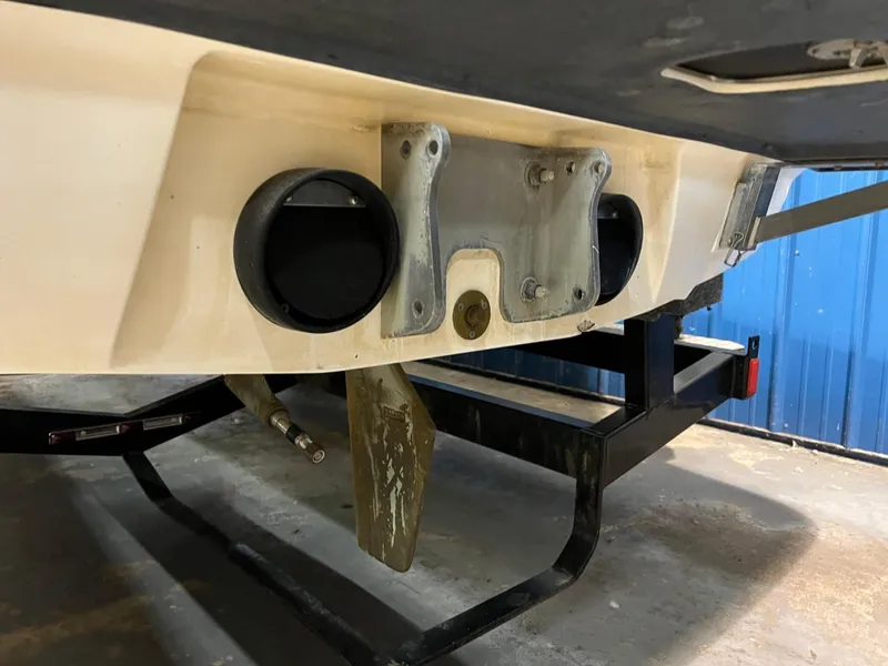 Slide: The Image of 2004 Malibu 20 Response LXI boat underside with trailer, showing propeller and rudder. - 15