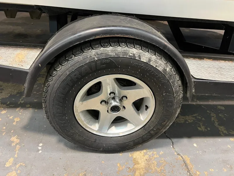 Slide: The Image of Trailer wheel of a 2004 Malibu 20 Response LXI boat. - 16