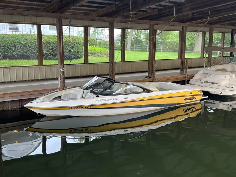 Slide: The Image of 2004 Malibu 20 Response LXI boat docked in covered marina. - 3