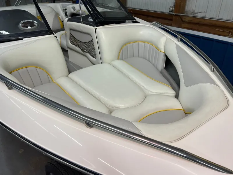 Slide: The Image of 2004 Malibu 20 Response LXI boat interior with white and yellow seating. - 4