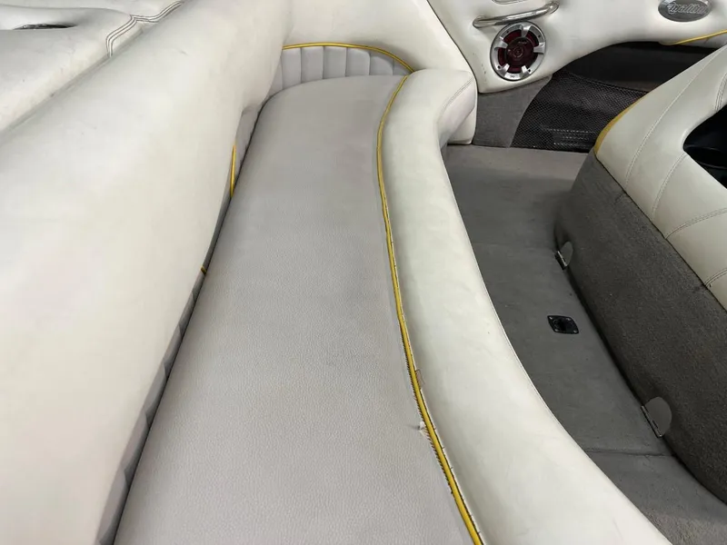 Slide: The Image of 2004 Malibu 20 Response LXI boat interior with white seating and yellow trim. - 5