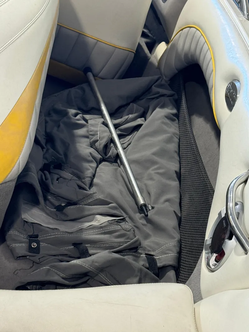 Slide: The Image of Interior of 2004 Malibu 20 Response LXI boat with cover and metal rod. - 9