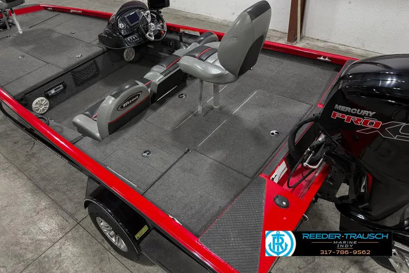Slide: The Image of 2018 Triton 18 TX boat interior with Mercury Pro engine, gray seating, and red accents. - 10