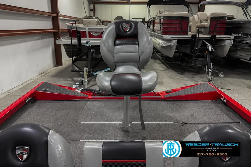 Slide: The Image of 2018 Triton 18 TX boat interior with seating in a showroom. - 13