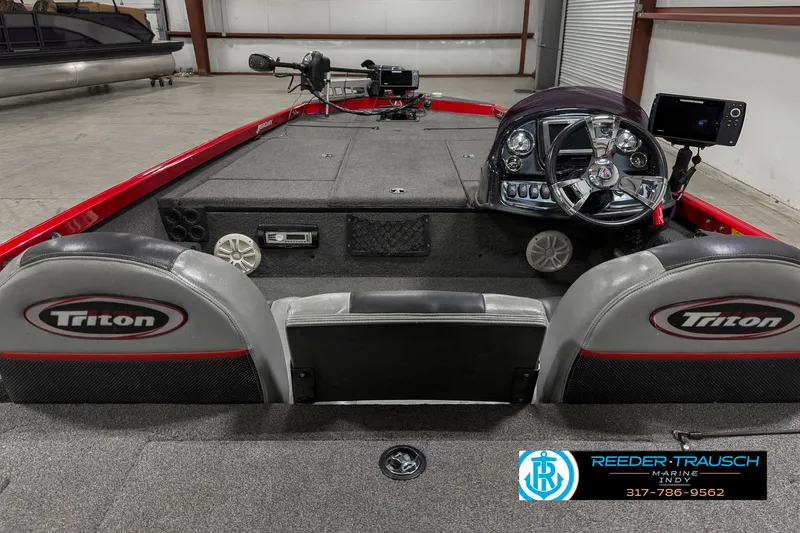 Slide: The Image of 2018 Triton 18 TX boat interior with steering console and seating. - 14