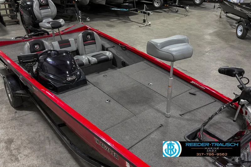 Slide: The Image of 2018 Triton 18 TX fishing boat with red exterior and spacious interior seating. - 19