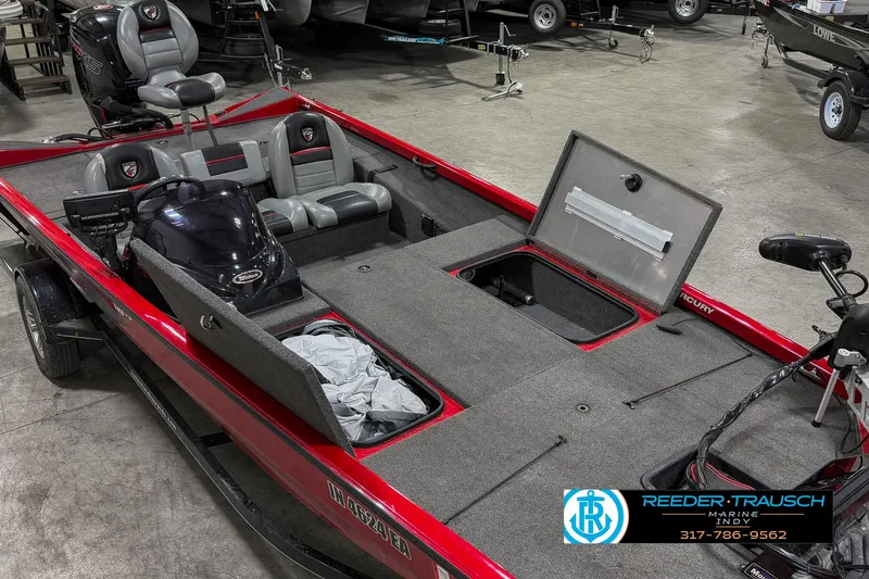 Slide: The Image of 2018 Triton 18 TX boat with open storage compartments in a showroom. - 20
