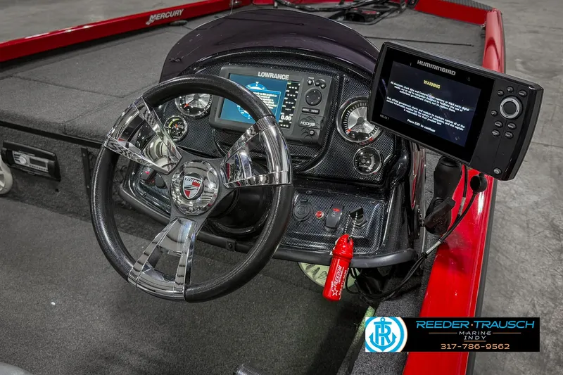 Slide: The Image of 2018 Triton 18 TX boat dashboard with steering wheel and electronic displays. - 26