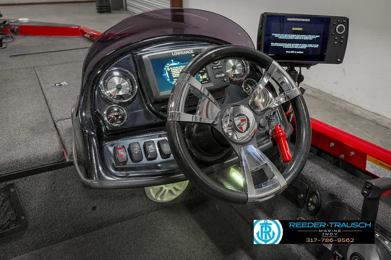 Slide: The Image of 2018 Triton 18 TX boat dashboard with steering wheel and electronic display. - 27