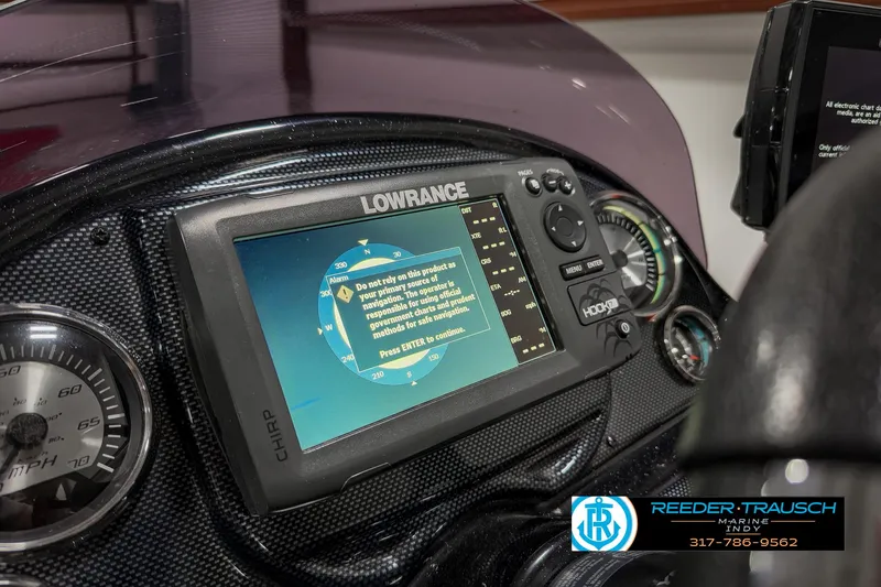 Slide: The Image of Lowrance fishfinder on 2018 Triton 18 TX boat dashboard, featuring gauges and controls. - 31