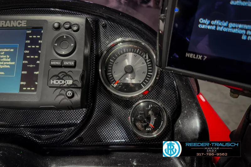 Slide: The Image of Dashboard of 2018 Triton 18 TX boat with gauges and navigation system. - 33