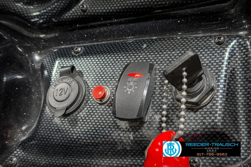 Slide: The Image of Control panel of 2018 Triton 18 TX boat with switches and 12V outlet. - 34