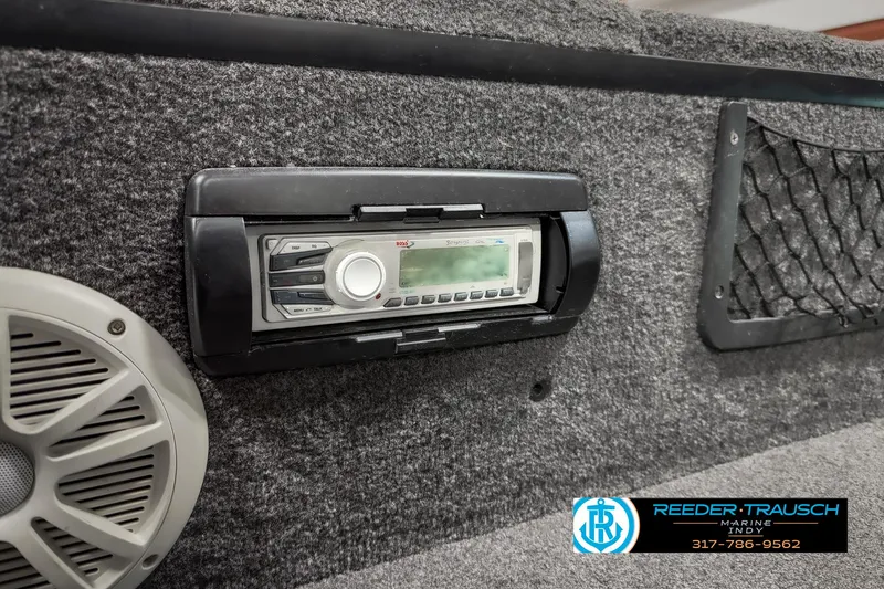 Slide: The Image of 2018 Triton 18 TX boat interior with stereo system and speaker. - 35
