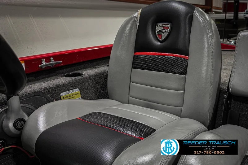 Slide: The Image of 2018 Triton 18 TX boat seat with black and gray upholstery, red accents, and logo. - 36
