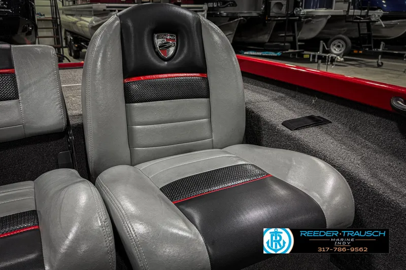 Slide: The Image of 2018 Triton 18 TX boat seat with black and gray upholstery, red accents. - 38