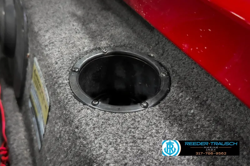 Slide: The Image of 2018 Triton 18 TX boat interior with circular compartment and red trim. - 39