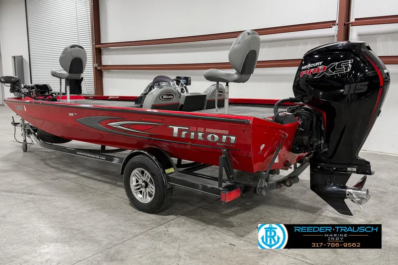 Slide: The Image of 2018 Triton 18 TX red fishing boat with Mercury outboard motor in showroom. - 4