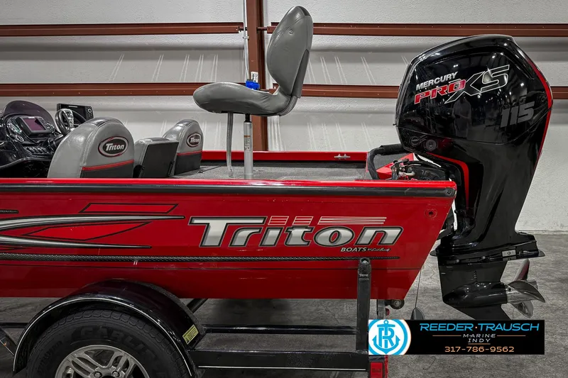 Slide: The Image of 2018 Triton 18 TX boat with Mercury Pro XS engine, displayed indoors. - 46