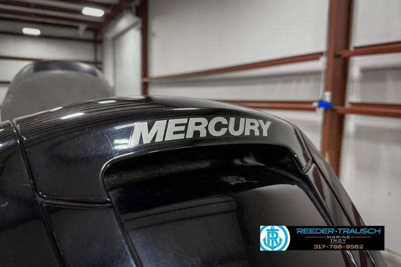 Slide: The Image of Close-up of Mercury engine on 2018 Triton 18 TX boat in warehouse. - 48